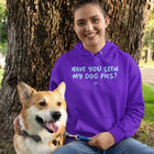 a woman and her dog in the park by a tree