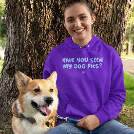 a woman and her dog in the park by a tree